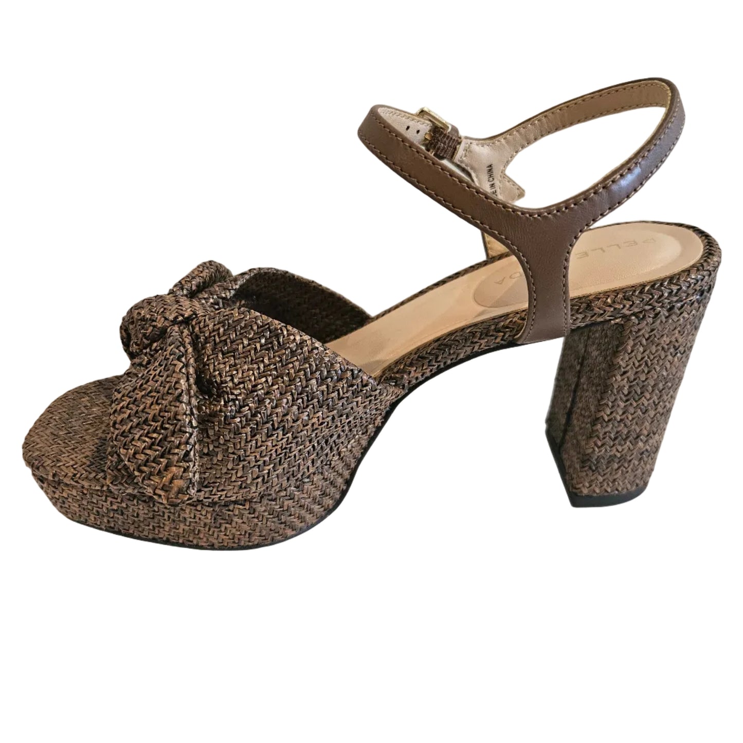 Brown woven sandal with a bow on a white surface
