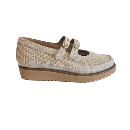 Beige shoe with a platform sole on a white surface