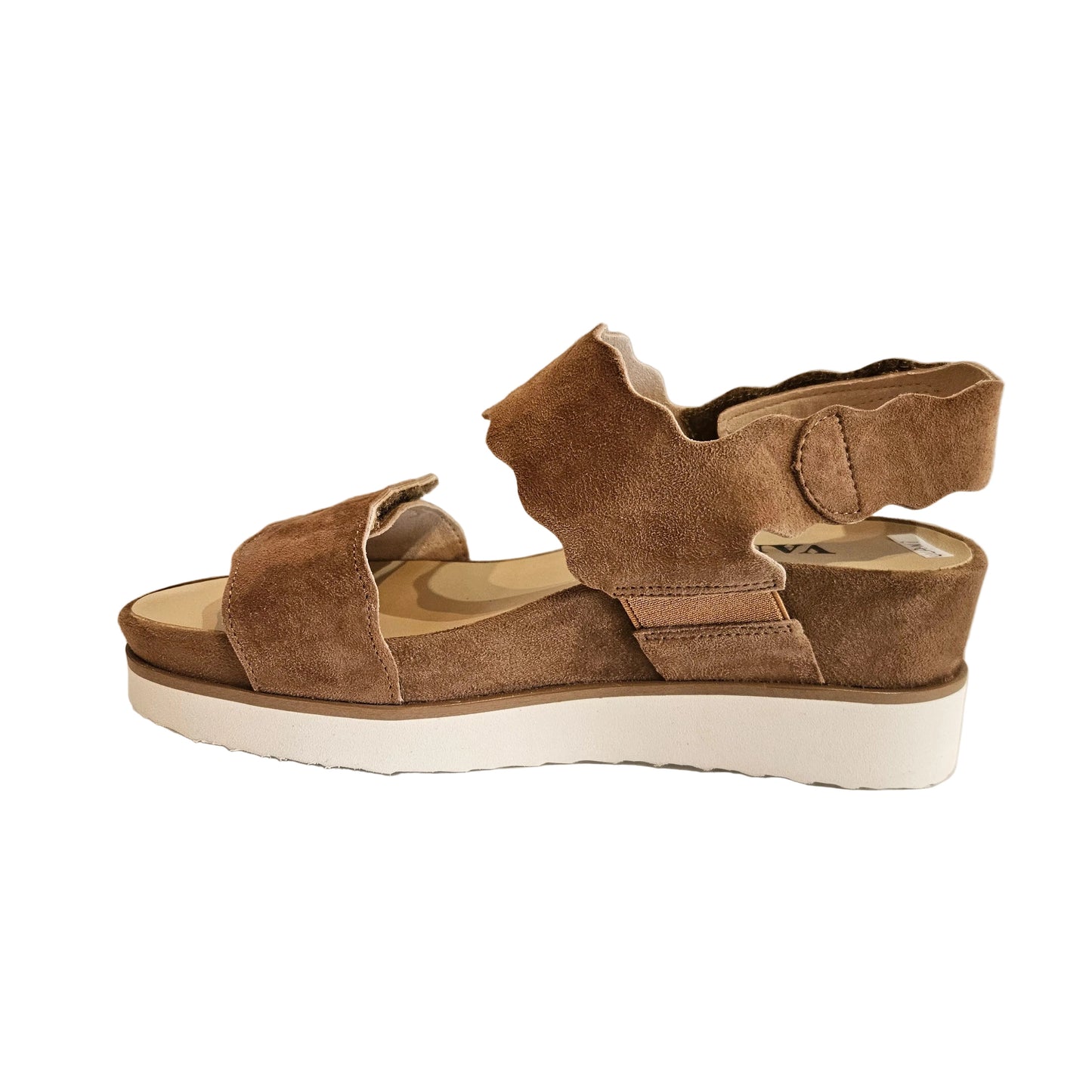 Brown suede sandals with white soles on a light surface