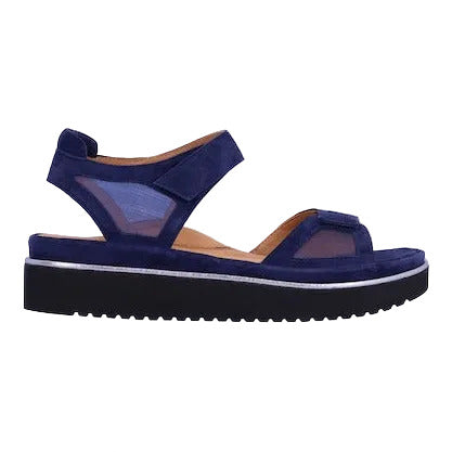 Blue sandal with a white sole on a light beige background